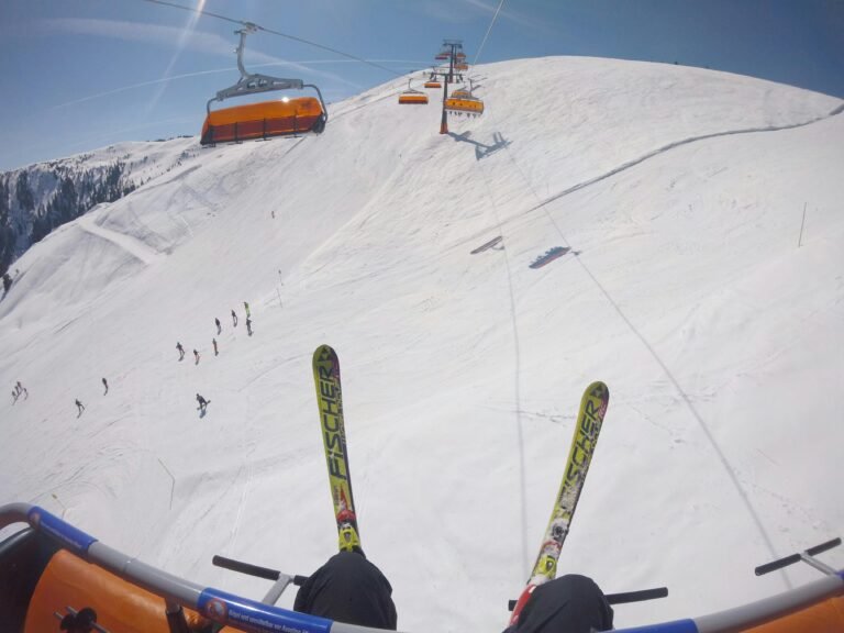 Skiers beneath a cable car in snowy Leogang, Austria. Beautiful winter sports scene.